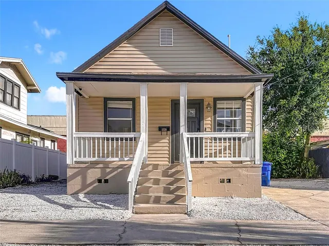 a front view of a house with wooden stairs