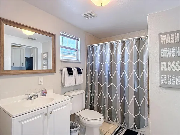 a bathroom with a sink toilet vanity and tub