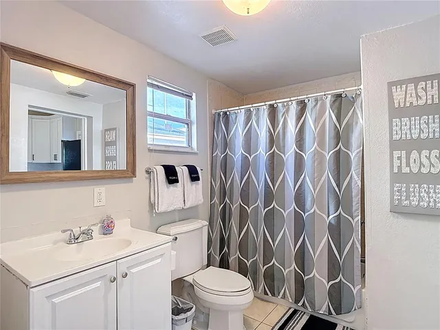 a bathroom with a sink toilet vanity and tub
