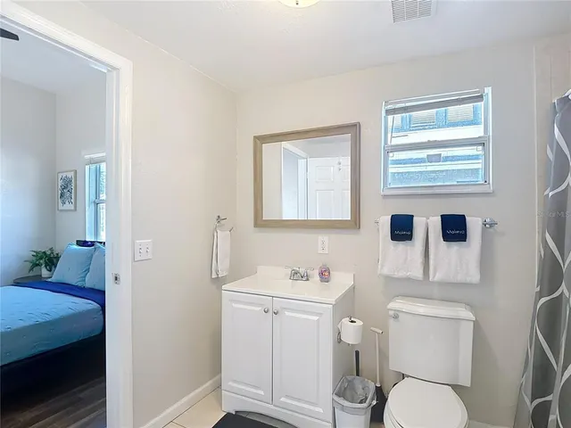 a view of a roof deck with table and chairs with wooden floor and fence