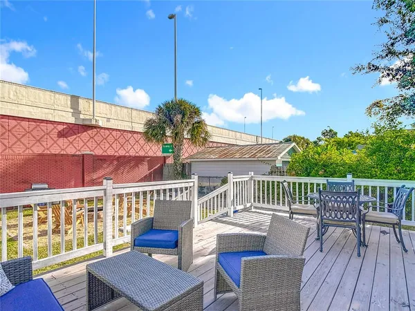 a view of a house with a chairs and table in the deck
