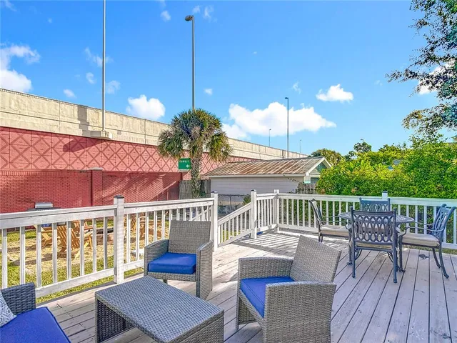 a view of a house with a chairs and table in the deck