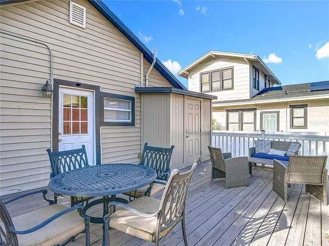 a backyard of a house with outdoor seating
