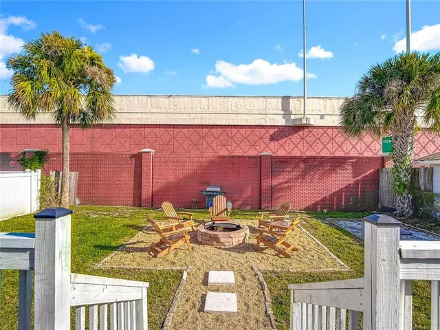 a view of a house with backyard and swimming pool