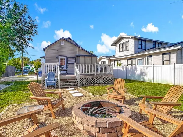 a view of a house with a yard and sitting area