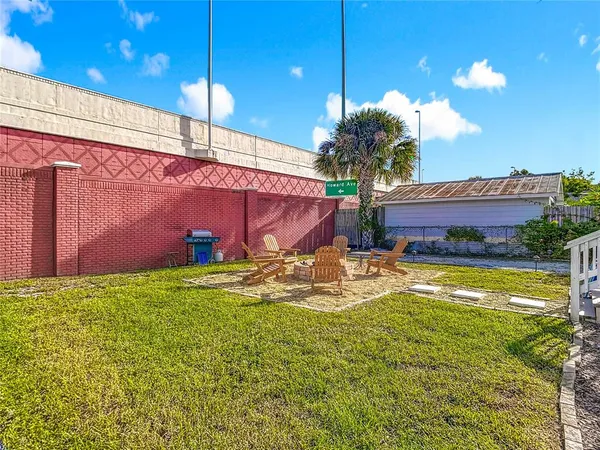 a view of a house with backyard and swimming pool