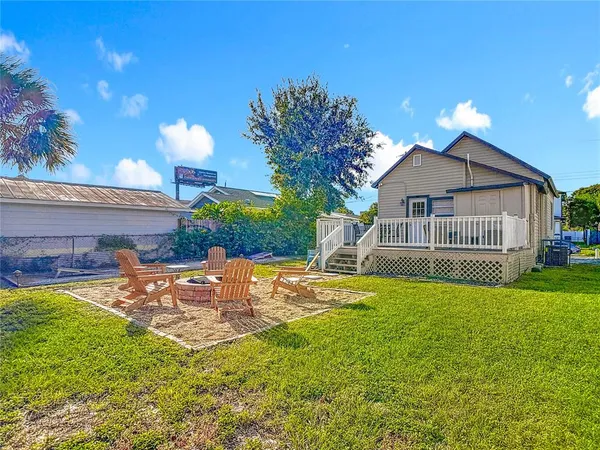 a view of a house with backyard and sitting area