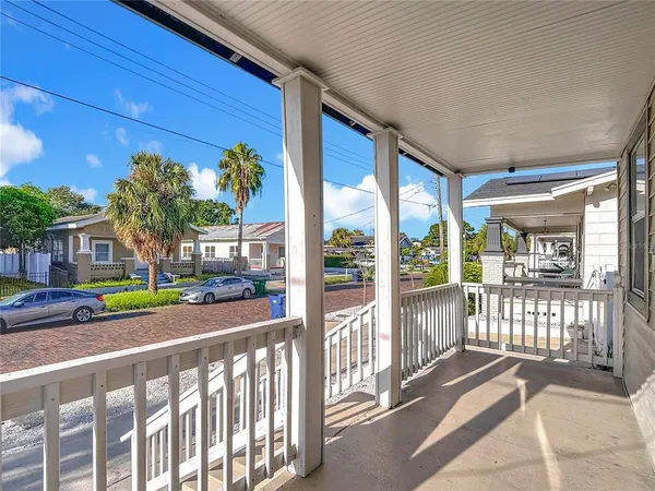 a view of a porch with wooden floor and fence