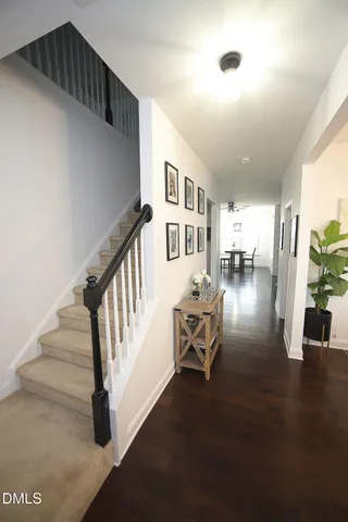 a view of entryway and hall with wooden floor