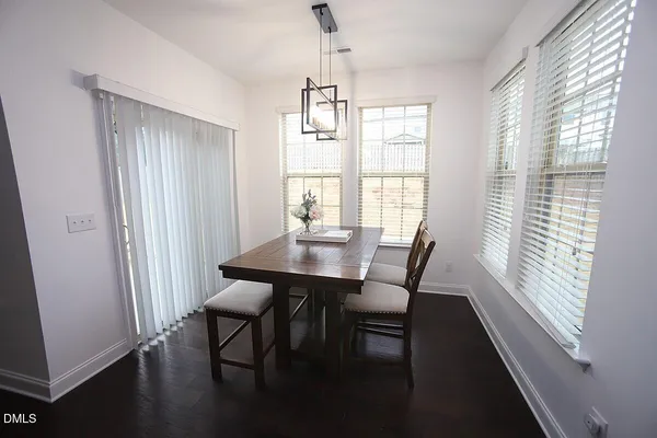 a view of a dining room with furniture window and wooden floor