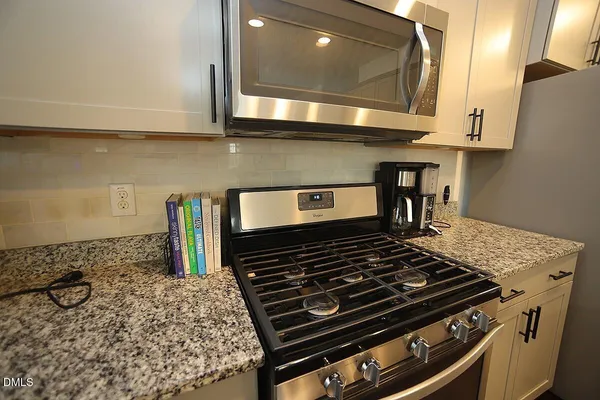 a stove top oven sitting inside of a kitchen