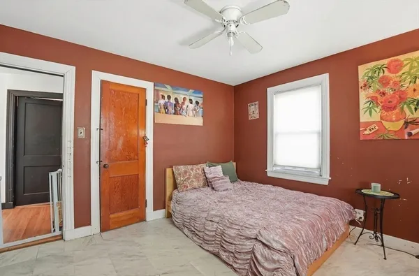 a bedroom with a bed and a chandelier