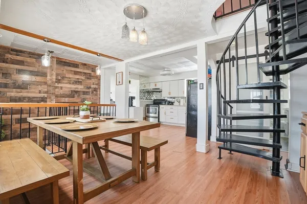 a view of a dining room with furniture and wooden floor