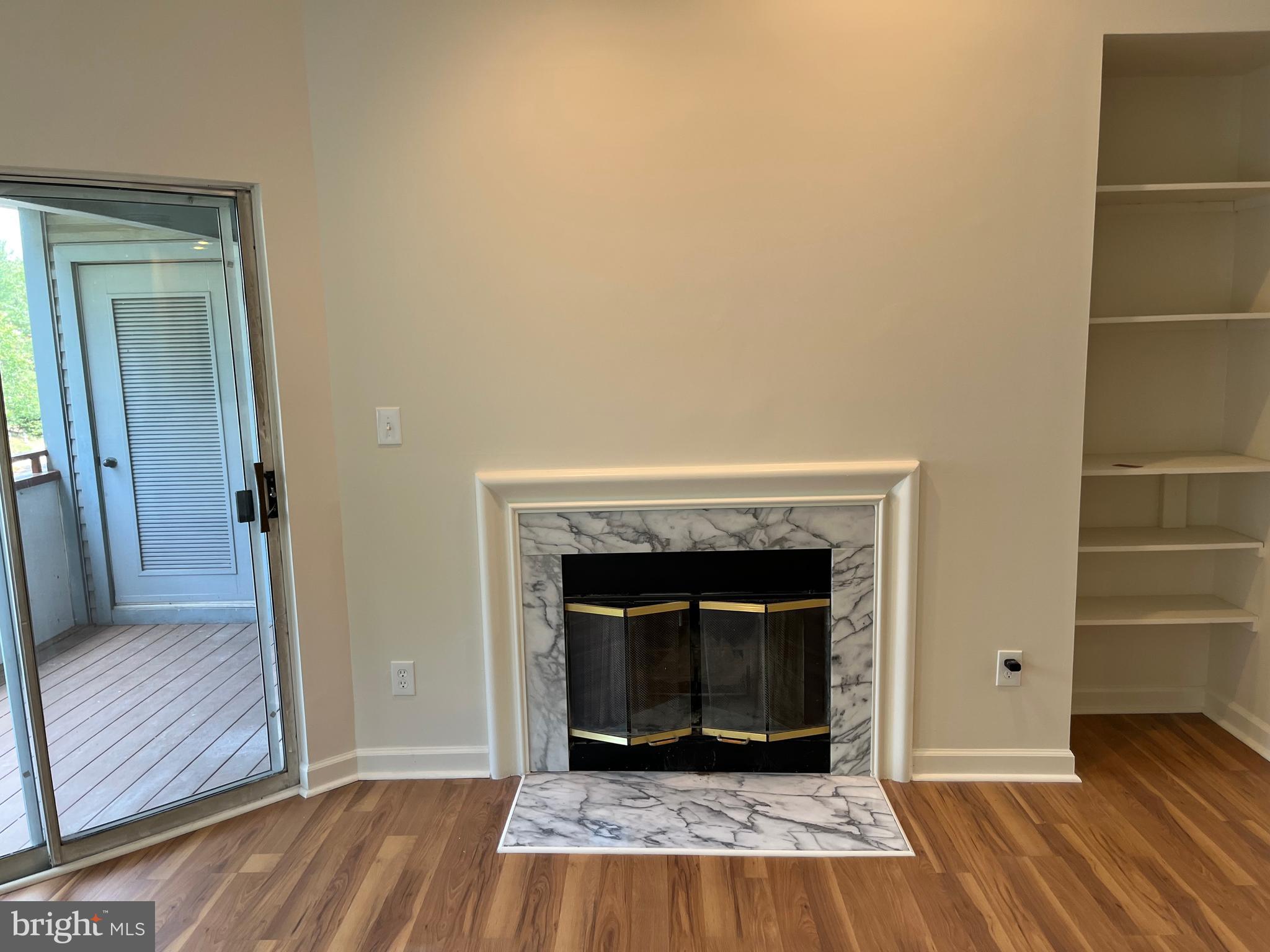 3301 Sir Thomas Drive, Unit 6B41 Silver Spring, MD 20904 - Photo 23 of 54 a view of a livingroom with wooden floor and a fireplace