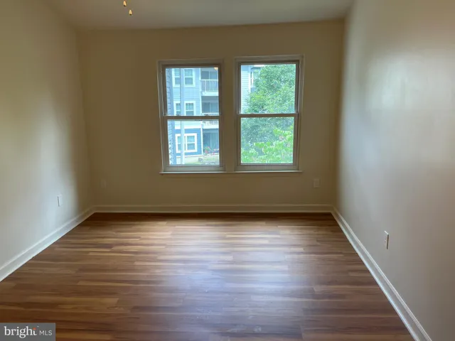 a view of small space with wooden floor and entrance