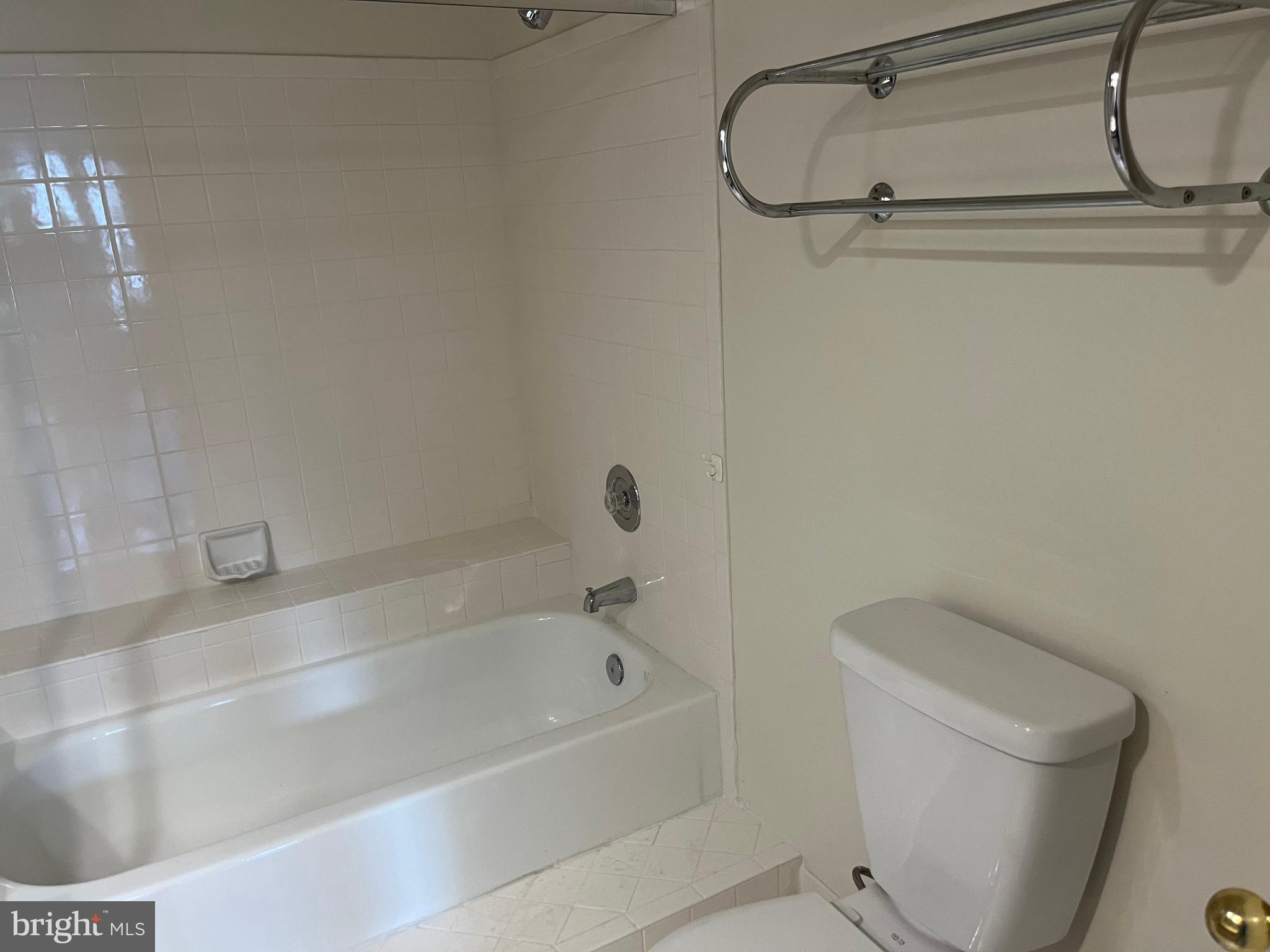 3301 Sir Thomas Drive, Unit 6B41 Silver Spring, MD 20904 - Photo 31 of 54 a bath tub sitting next to a white toilet and sink