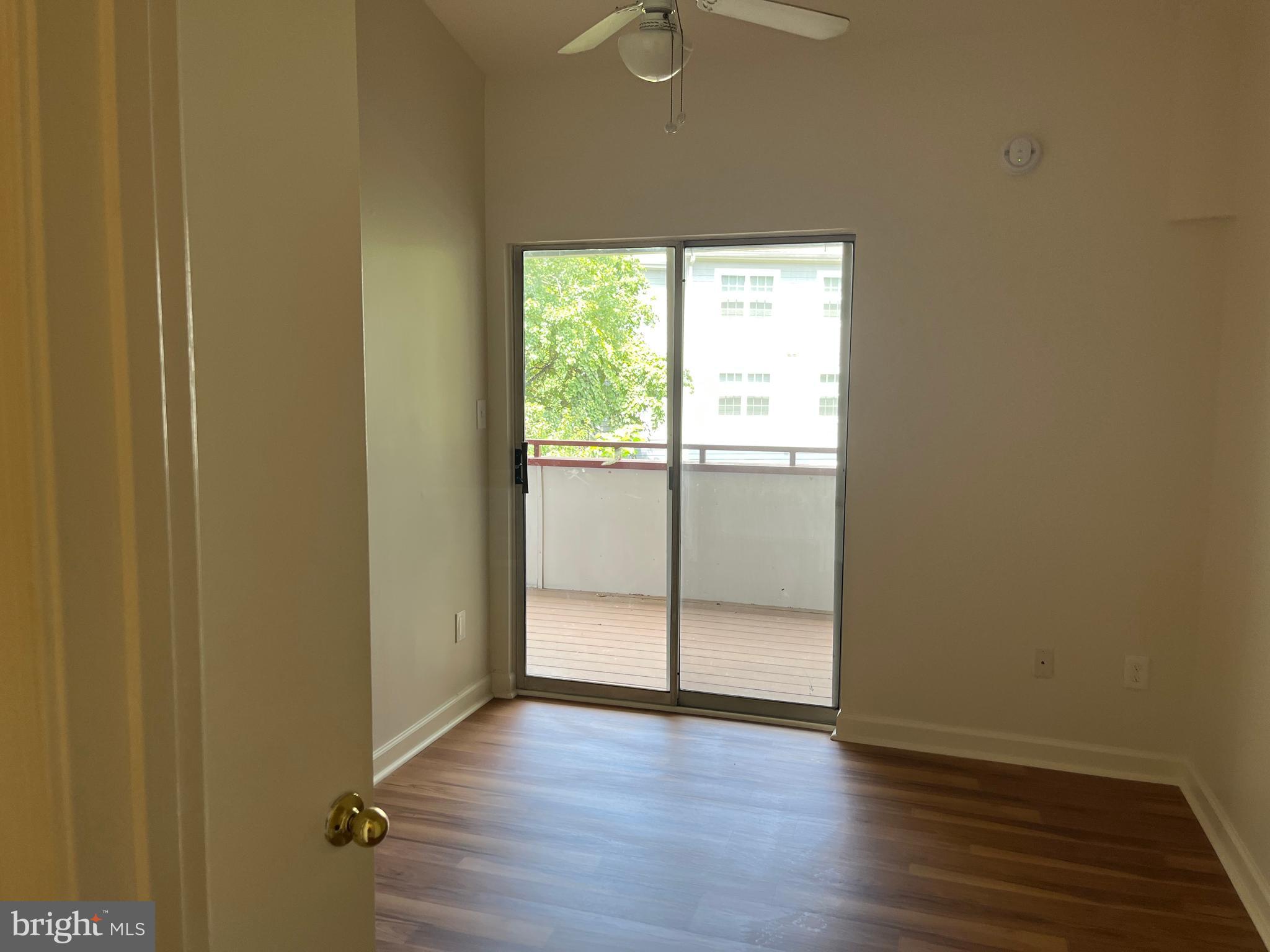 3301 Sir Thomas Drive, Unit 6B41 Silver Spring, MD 20904 - Photo 32 of 54 an empty room with wooden floor and windows