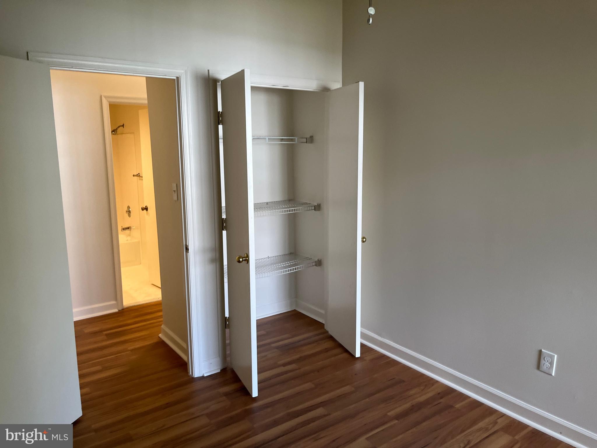 3301 Sir Thomas Drive, Unit 6B41 Silver Spring, MD 20904 - Photo 35 of 54 a view of an empty room with wooden floor and a bathroom