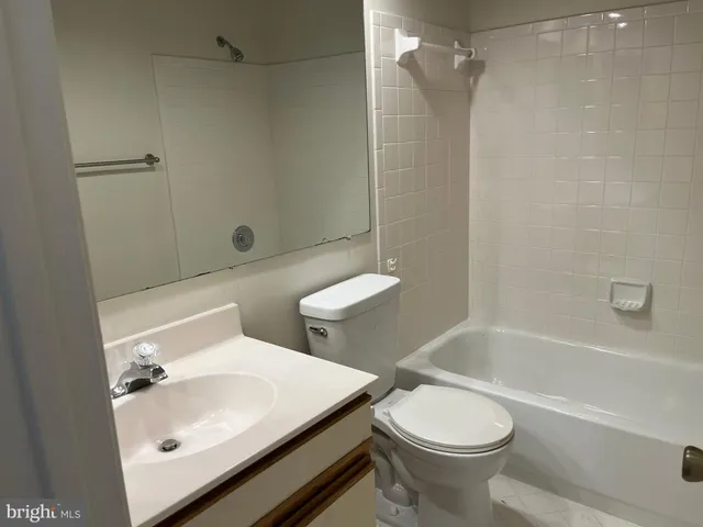 a living room with furniture wooden floor and a large window