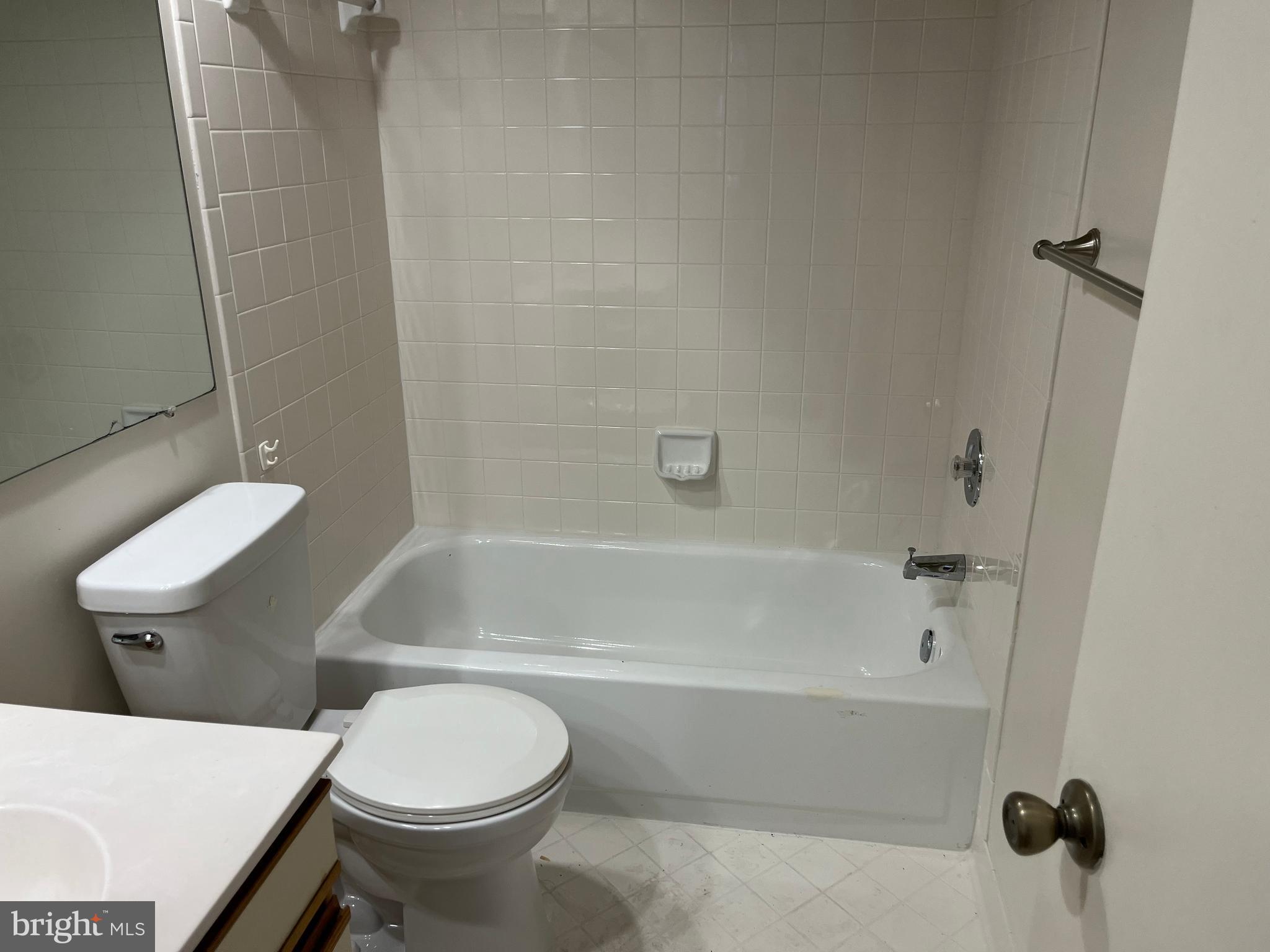 3301 Sir Thomas Drive, Unit 6B41 Silver Spring, MD 20904 - Photo 39 of 54 a bathroom with a toilet and a bath tub