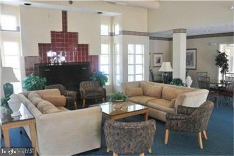 3301 Sir Thomas Drive, Unit 6B41 Silver Spring, MD 20904 - Photo 52 of 54 a living room with fireplace furniture and a large window