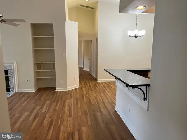 a kitchen with a refrigerator and a stove top oven