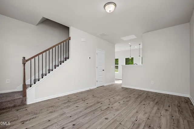 a view of hallway with wooden floor
