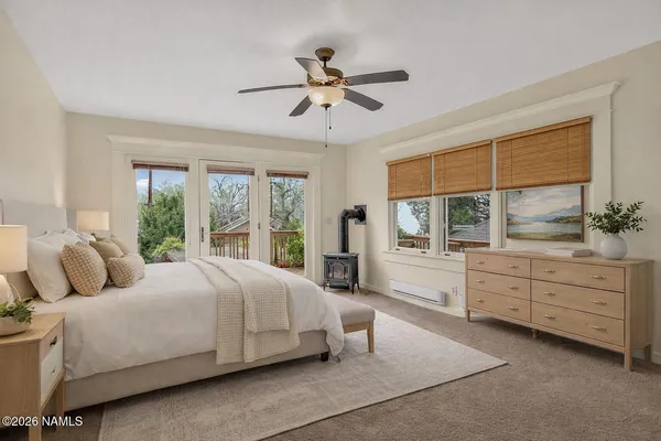 a bedroom with a large bed and a window