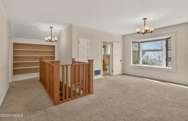 wooden floor chandelier and windows in a room