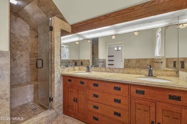 a bathroom with a granite countertop sink mirror and double