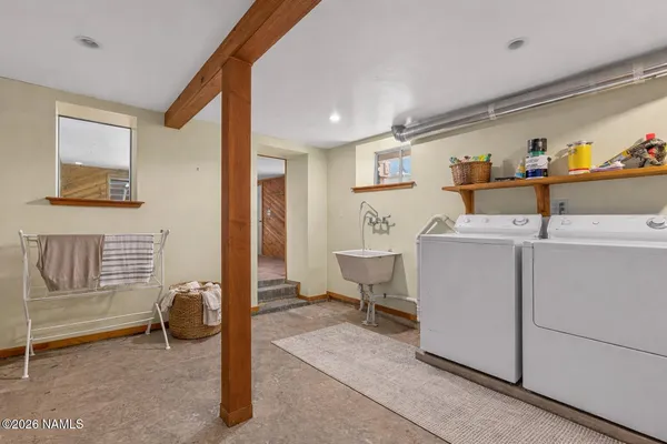 a white house that has tree in front of it