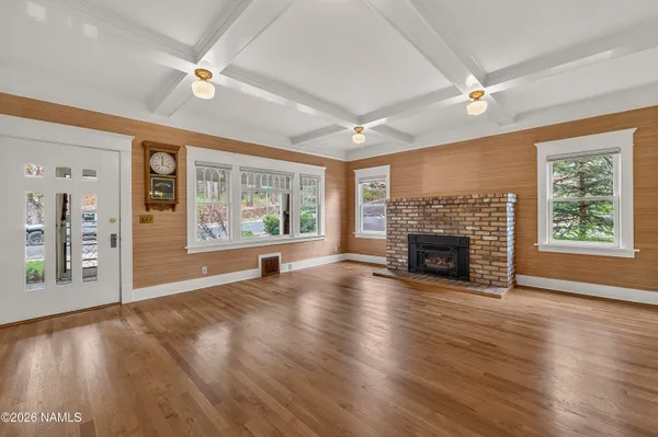wooden floor fireplace and windows in an empty room