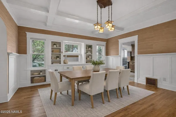 a view of a dining room with furniture a chandelier and wooden floor