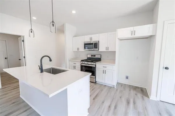 a kitchen with a sink a stove and refrigerator