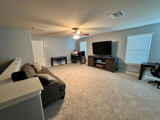 a bedroom with a bed chair and a chandelier