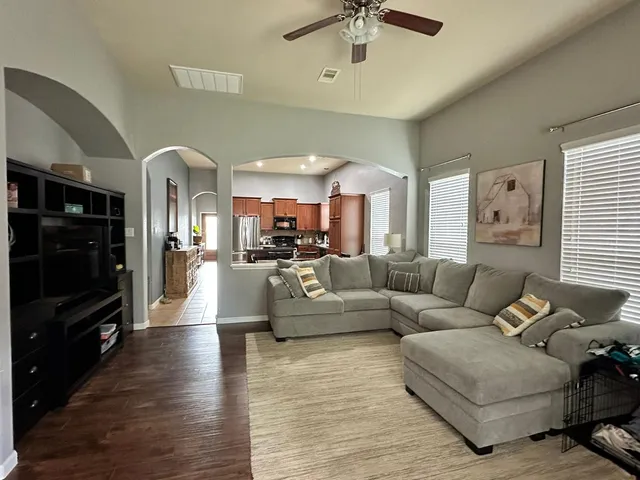 a living room with furniture and a flat screen tv
