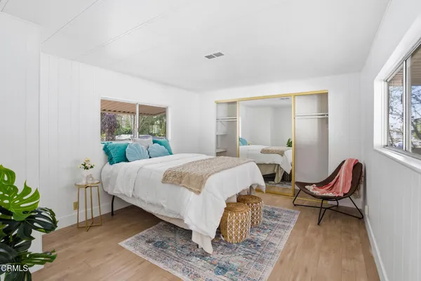 a bed room with a bed and a chair