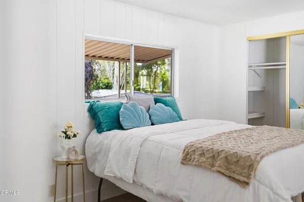 a bedroom with a bed and a table