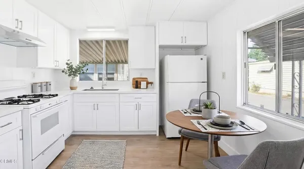 a kitchen with a stove a sink and a refrigerator