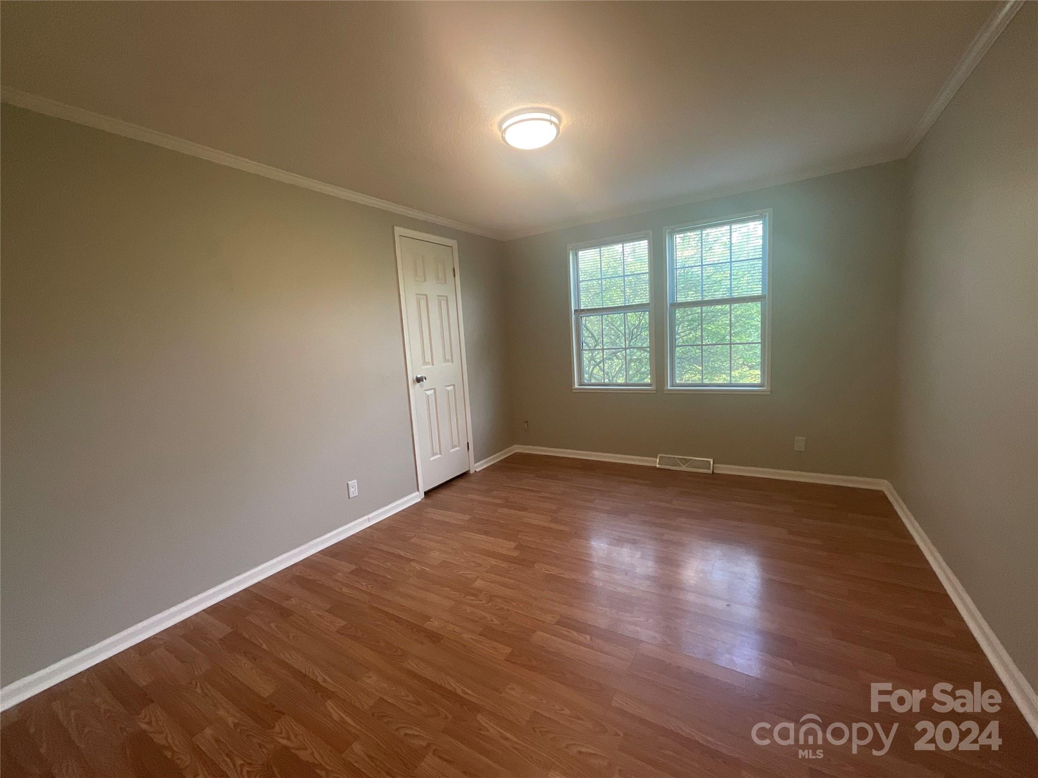 900 Jim Elliott Road Shelby, NC 28150 - Photo 22 of 29 an empty room with wooden floor and windows