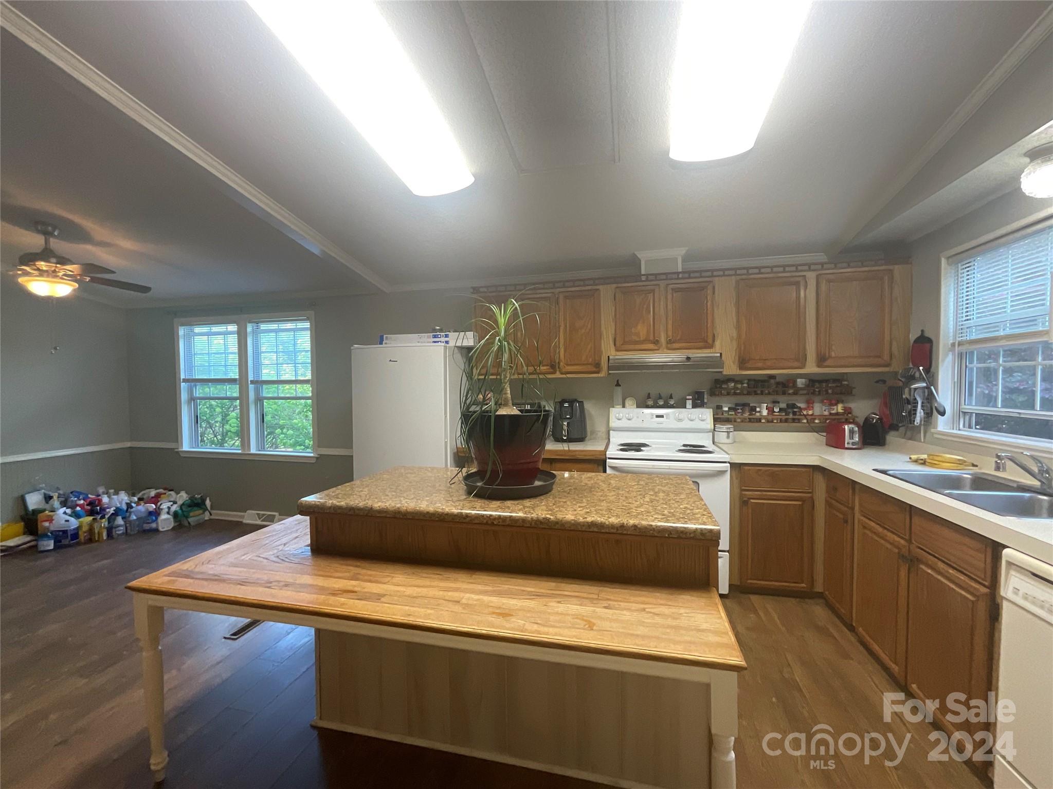 900 Jim Elliott Road Shelby, NC 28150 - Photo 10 of 29 a kitchen with kitchen island a stove a sink a refrigerator and cabinets