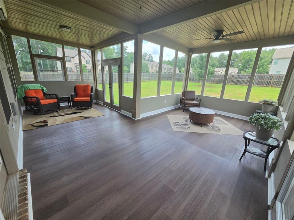 801 Relic Ridge Hampton, GA 30228 - Photo 32 of 44 a living room with furniture floor to ceiling window and wooden floor
