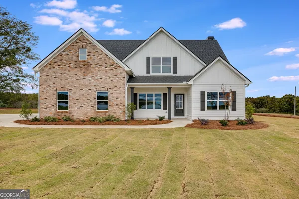 a view of a house with swimming pool and a yard