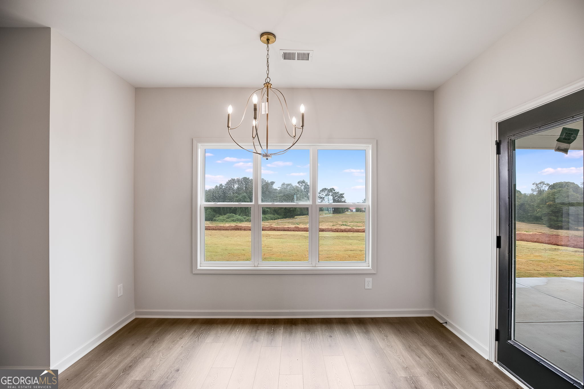 12 Stewart Road Roopville, GA 30170 - Photo 13 of 48 a view of an empty room with wooden floor and a window