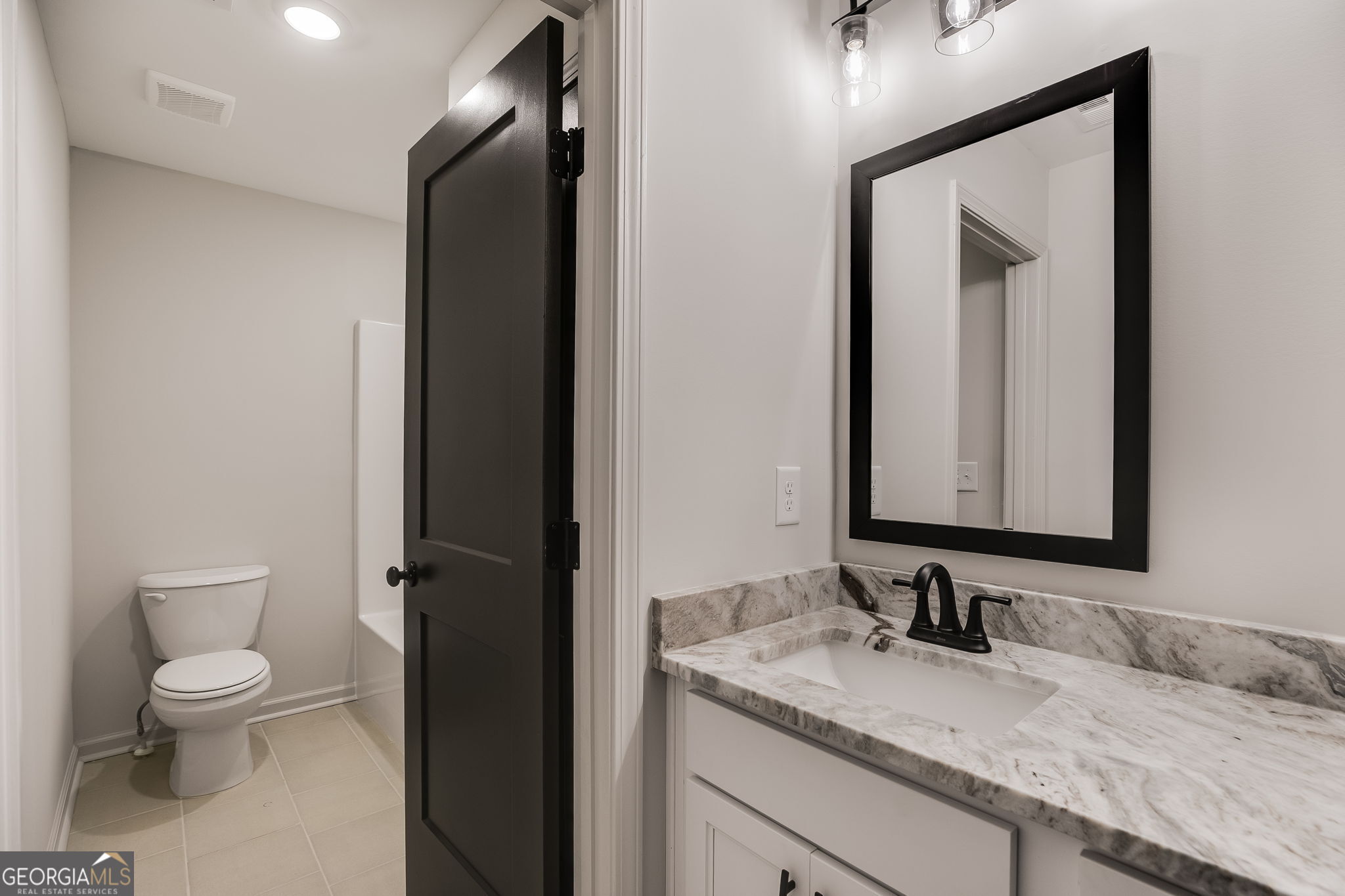 12 Stewart Road Roopville, GA 30170 - Photo 34 of 48 a bathroom with a granite countertop sink toilet and mirror