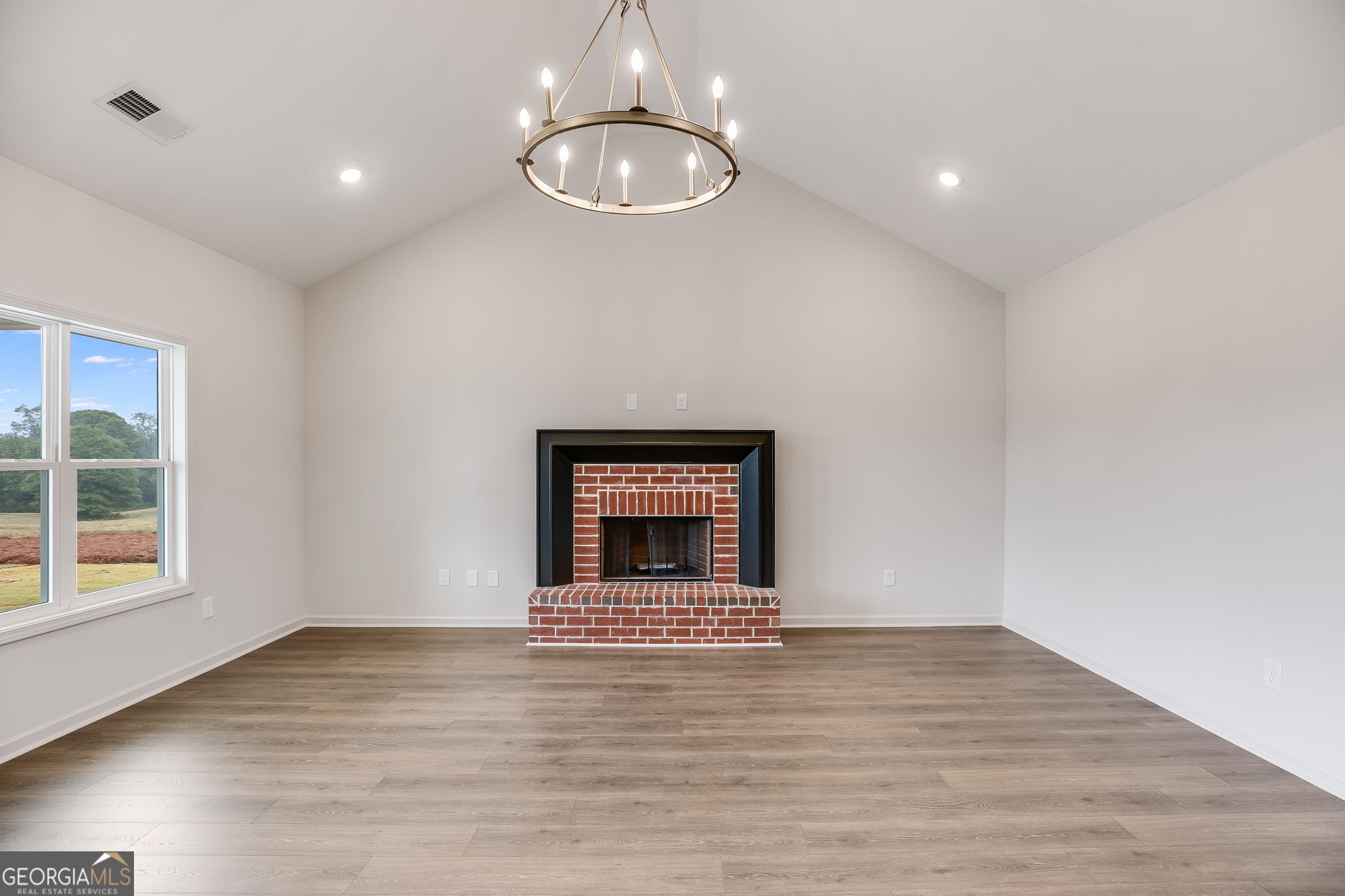 12 Stewart Road Roopville, GA 30170 - Photo 7 of 48 a view of an empty room with wooden floor and a window