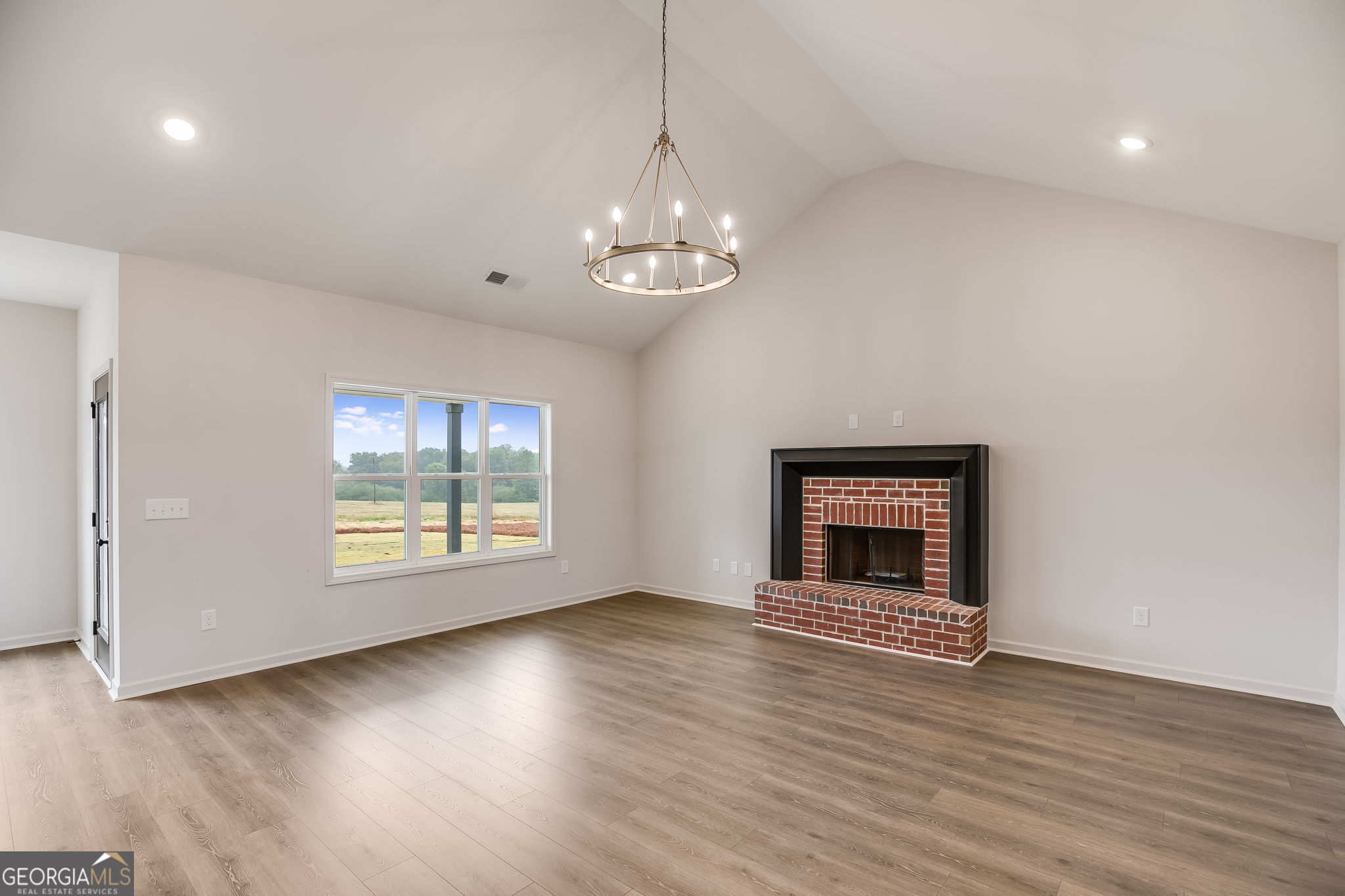 12 Stewart Road Roopville, GA 30170 - Photo 8 of 48 a view of an empty room with window and wooden floor
