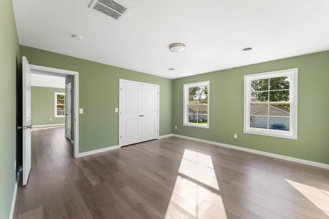 wooden floor in an empty room with a window