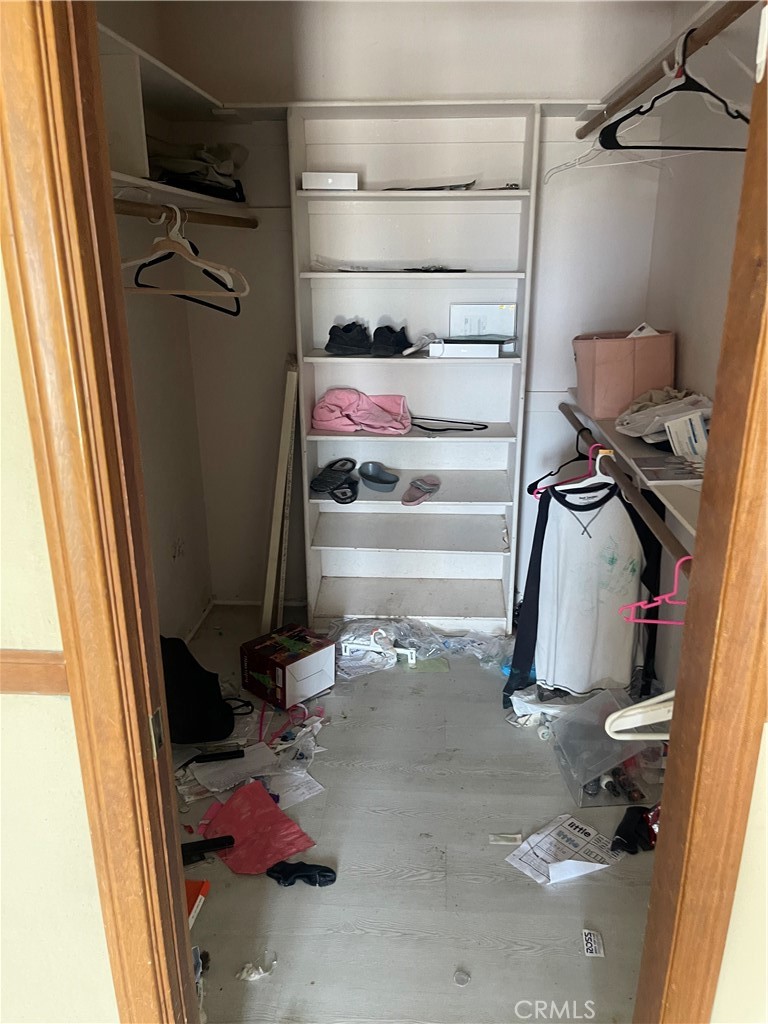 23859 Papago Road Apple Valley, CA 92307 - Photo 14 of 32 a view of walk in closet with clothes and shoes