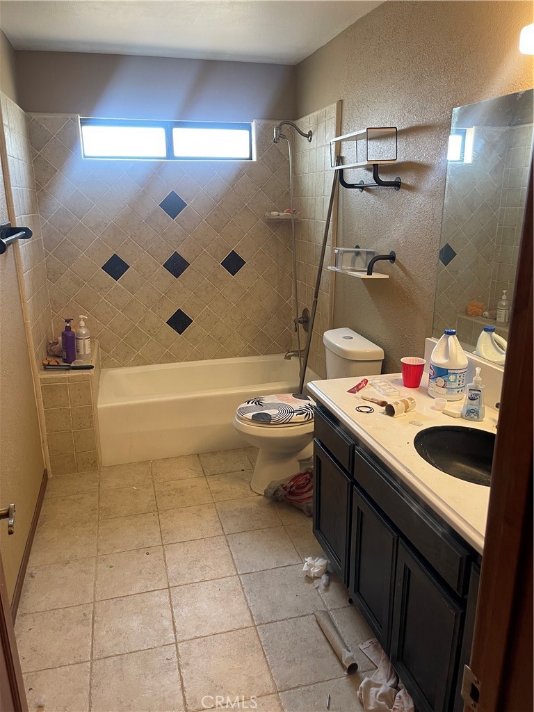 23859 Papago Road Apple Valley, CA 92307 - Photo 16 of 32 a bathroom with a sink a toilet and shower